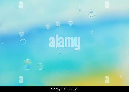 Soft abstract blue, cyan and yellow gradient background with blurred bubbles, smooth texture, minimal composition, horizontal banner with copy space. Stock Photo