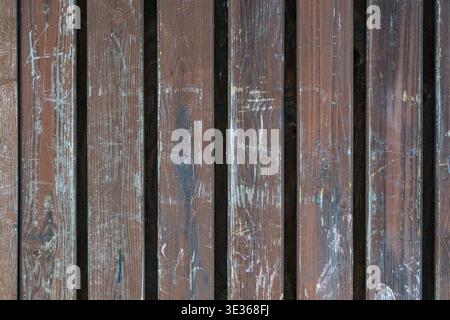 Close up of vertical wooden boards with visible scratches, stains, and aged surface. Stock Photo