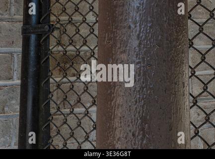 A view of a closed gate around a awimming pool Stock Photo