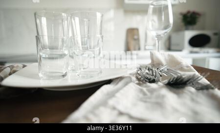 Clean Dishes And Forks Lying On The Table In The Kitchen Stock Photo