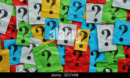 A pile of colorful notes with question marks on them. Too many questions. Close up. Stock Photo