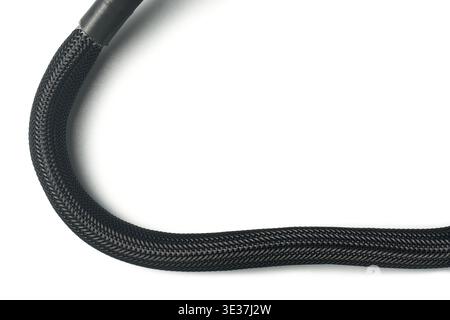 black braided power cable sleeve isolated white background, matte synthetic fiber mesh texture on curved wire, nylon electrical cord protector Stock Photo