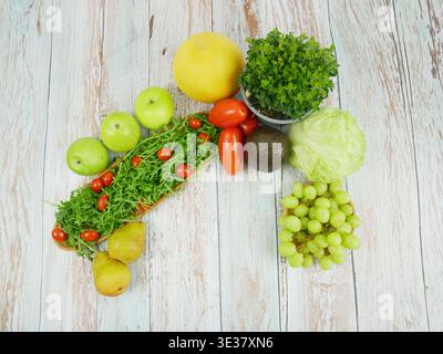 Assorted fruits and vegetables displayed on a wooden surface Stock Photo