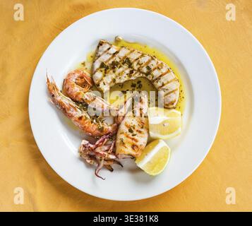Travel to Italy, italian cuisine - top view of various sicilian grilled fish and seafood on white plate in Sicily Stock Photo