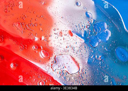 Creative blue white and red paint splatters on textured canvas representing the flag of France. Stock Photo