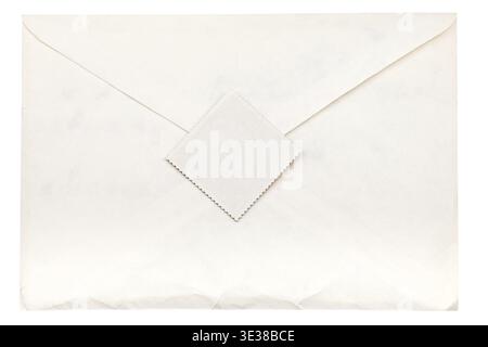 Closed paper envelope sealed by postage stamp isolated on white background Stock Photo