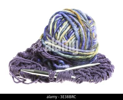 Ball of multi-colored yarn and knitting needles in knitted cloth isolated on white background Stock Photo