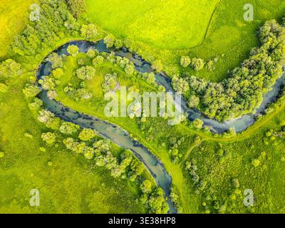In the Weisspriach Valley, clear water flows through green trees and ...