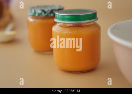 Jars of baby food on a simple background Stock Photo
