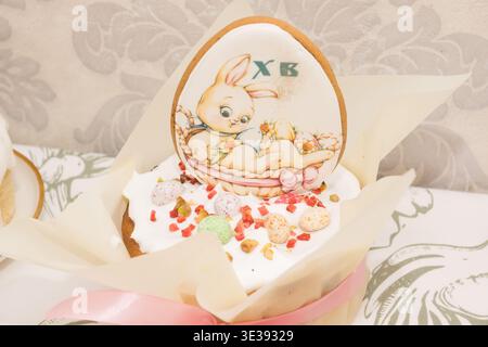 Traditional Easter dinner or brunch with ham, colored eggs, hot cross buns, cake and vegetables. Easter meal dishes with holday decorations. Stock Photo