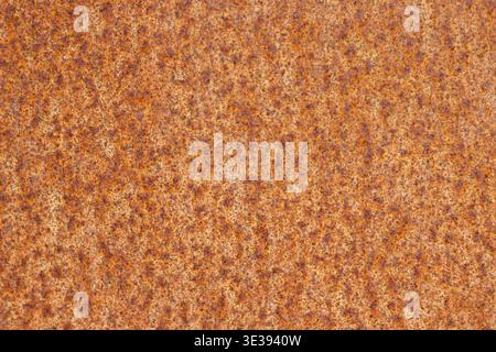Close-up of rusty metal surface with orange and brown corrosion spots Stock Photo