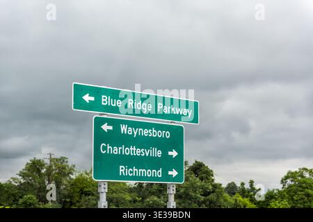 Virginia road sign to Blue Ridge Parkway, city of Waynesboro Charlottesville and Richmond by rural countryside road highway Stock Photo