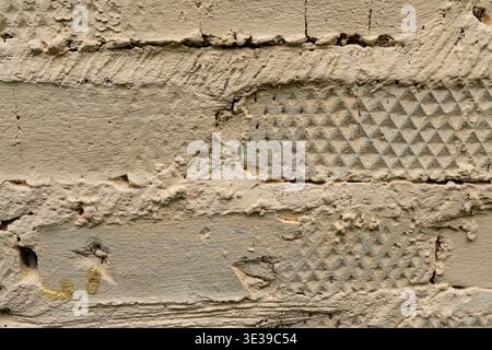 Detailed texture of rough beige plastered brick wall surface with indentations Stock Photo