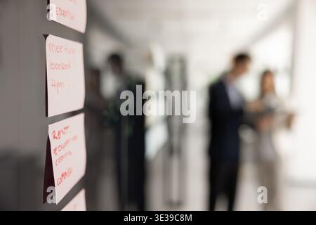 Sticky notes on board with written tasks and project plan Stock Photo