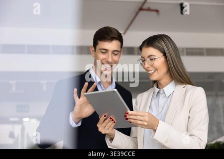 Team members using digital tablet, working on joint project Stock Photo
