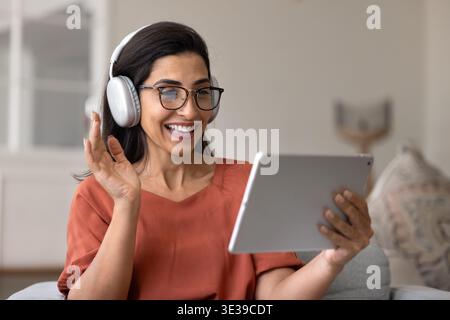 Smiling woman having video call on tablet at home Stock Photo