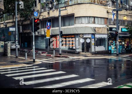 Tel Aviv, Israel, March 21, 2026 Street view of Tel Aviv under the rain with light reflections on the wet pavement and moody urban atmosphere. Stock Photo
