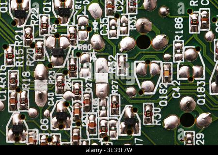 Electronic circuit board closeup with soldered components. Computer hardware and digital technology background with microelectronics detail. Stock Photo