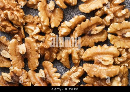 Walnuts closeup on dark background. Healthy natural food texture. Organic nuts full of nutrition and plant based energy source. Stock Photo
