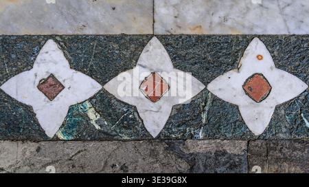Marble floor of Santa Croce Basilica with an inlay of white marble stars and red diamonds set into dark green serpentine stone Florence, Italy Stock Photo