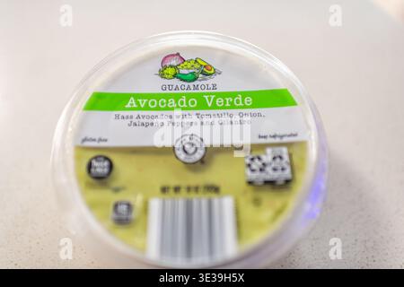 Roseland, USA - February 18, 2025: Closeup of plastic container cup of avocado salsa verde green guacamole variety by Park street deli Aldi brand Stock Photo