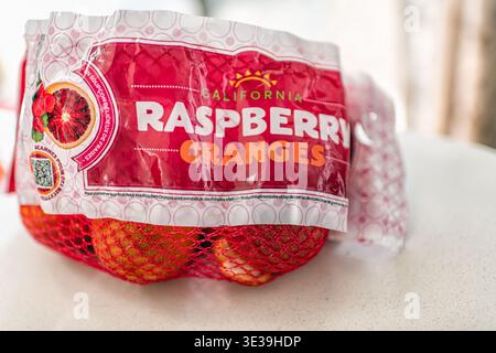 Roseland, USA - March 4, 2025: Raspberry blood oranges citrus fruits sweet fruit food in mesh net bag macro closeup from California Stock Photo