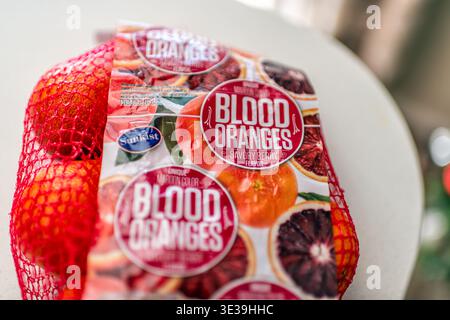 Roseland, USA - March 14, 2025: Blood oranges citrus fruit sweet fruits food in mesh net bag with Sunkist Sk brand sign label for savory berry flavor Stock Photo