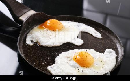 Close Up View Of Fried Eggs In A Frying Pan Stock Photo
