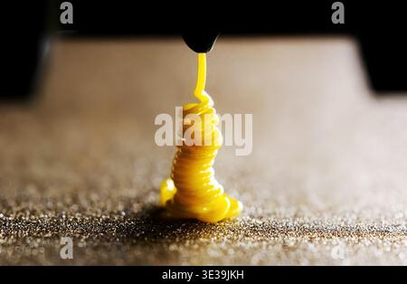 3D Printer Nozzle Cleaning Process, Printing With Yellow TPU Filament, Replacing filament Stock Photo