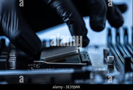 Repairman Installing Main Processor Chip On Motherboard In Service Stock Photo