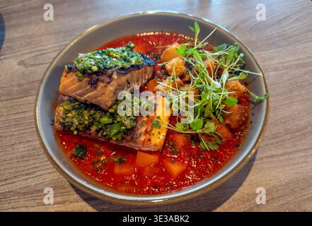 Grilled Salmon in Lebelebi stew with butternut squash, chickpea, harissa, rapini relish Stock Photo