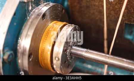 Metalworking creating threaded rod on industrial lathe machine Stock Photo