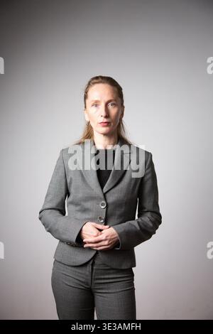 Vertical photo. A woman in a business suit with her arms folded. Stock Photo
