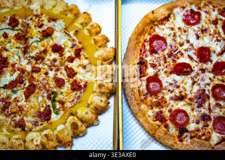 Pepperoni Pizza and Mexican pizza with Melted Cheese and Crispy Crust on box Stock Photo