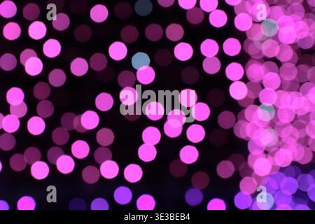 Abstract pink and purple bokeh background. Defocused soft lights creating a romantic and dreamy atmosphere for elegant creative design. Stock Photo