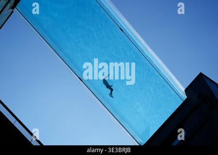A swimmer in the Sky Pool, a transparent swimming pool suspended 35 ...