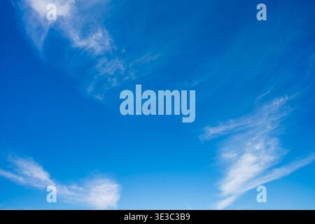 A vibrant blue sky with wispy white cirrus clouds captured above a Bedouin village in Hurghada, Red Sea Governorate, Egypt. Stock Photo