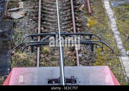 Current collector on an electrically powered locomotive, power cable, overhead line, traction current, Germany. Stock Photo