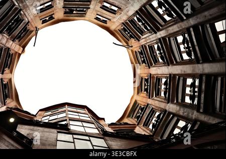 Looking up through the interior courtyard light well of Casa Milà (La Pedrera), Antoni Gaudí's modernist landmark, Barcelona, Spain. Stock Photo