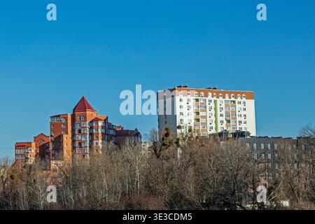 Modern multi-storey houses on a sunny day along the highway. Real estate Stock Photo