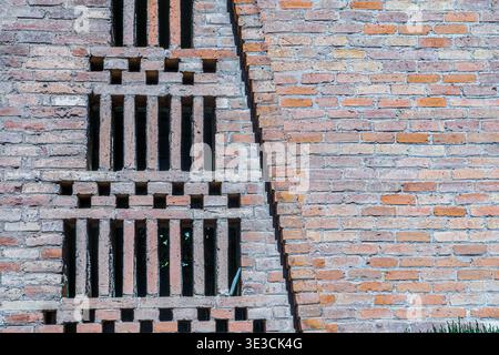 Abstract brick wall with vertical ventilation openings Stock Photo