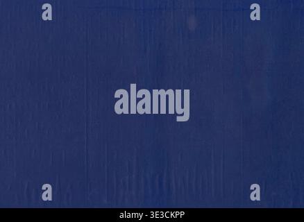 Dark-blue surface with dents, unevenness. Surface of dark blue paper or cardboard, background, texture. Backdrop of pressed, wrinkled surface. Navy ca Stock Photo