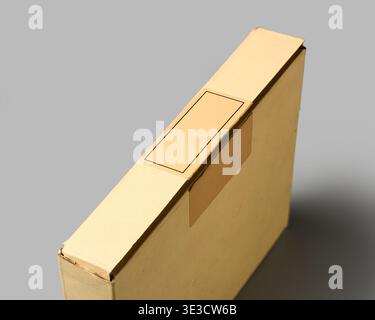 closed cardboard box with blank broken security seal isolated gray background, compromised or tampered seal concept in soft focus Stock Photo
