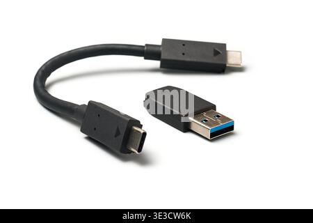 usb-c cable and adapter isolated white background, black plastic metal construction with usb-a converter, side view with soft focus Stock Photo