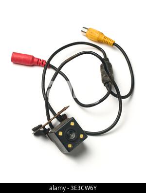 old used car backup camera with cables isolated white background, dirty plastic metal housing with rca connectors, top view Stock Photo