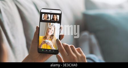 Millennial Lady Using Smartphone and Smart Watch While Relaxing in Living Room Stock Photo