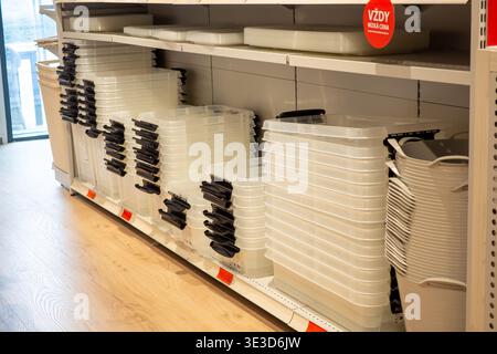 Plastic containers are neatly stacked on store shelves. Brno March 21, 2026 Stock Photo