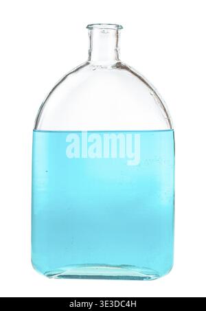 Blue ink solution in water in glass flask against white background Stock Photo