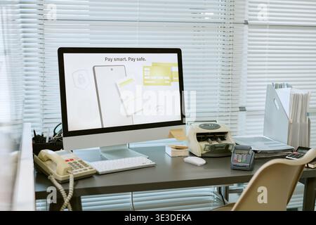 Modern Bank Branch Office Desk Featuring Computer and Payment Devices Stock Photo