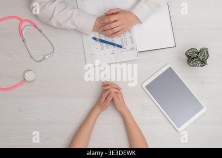 top view medical desk with tablet stethoscope and documents providing copy space for healthcare and digital health concepts Stock Photo